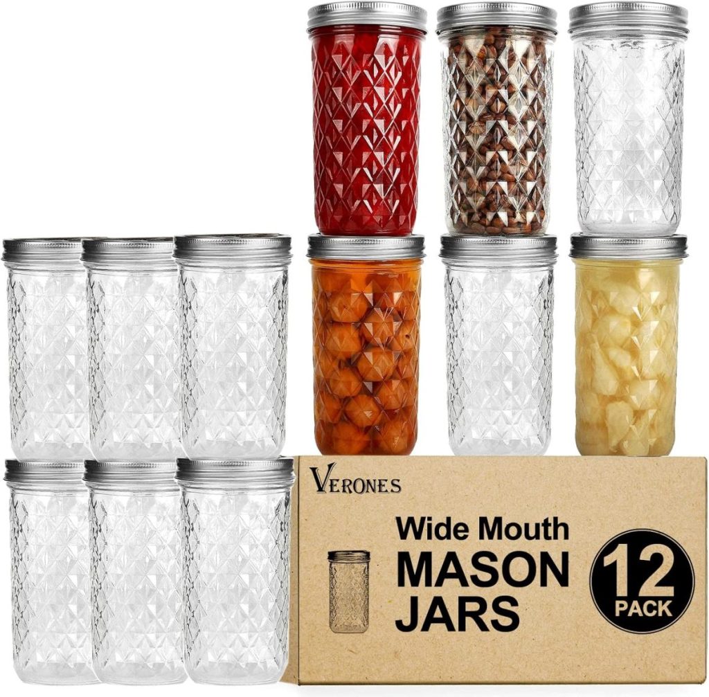 Twelve wide mouth mason jars with silver lids are arranged above a box labeled “Wide Mouth Mason Jars 12 Pack”; some jars contain various preserved foods or the best iced tea for fresh serving.