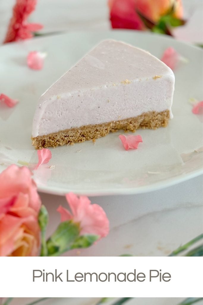 A slice of pink lemonade pie on a white plate, garnished with pink flower petals, with text "Pink Lemonade Pie" at the bottom.