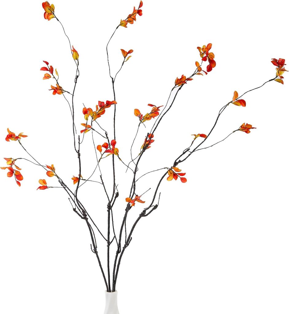 A white vase holds several thin, dark branches with small orange and red flowers, making it a perfect piece for fall home decor against a crisp white background.