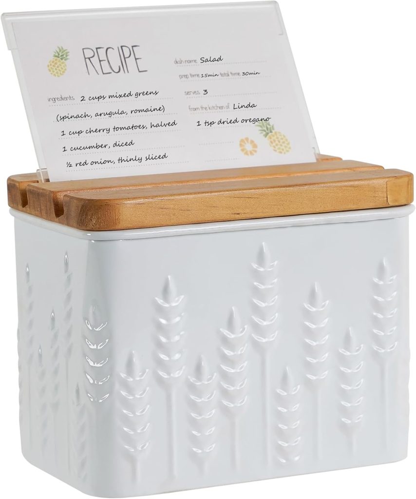 A white metal recipe box with a wheat pattern, a wooden lid, and an open recipe card displayed on top—perfect as a thoughtful house guest gift.