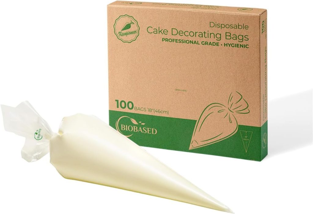 A box of 100 disposable cake decorating bags, perfect for crafting flower cakes, with one filled piping bag in front; packaging is labeled biobased and hygienic.