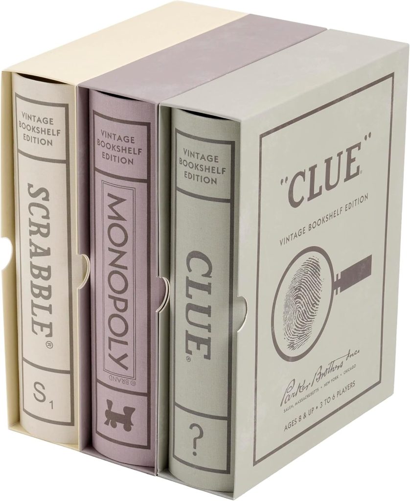 Three board games—Scrabble, Monopoly, and Clue—are packaged in book-shaped boxes with a slipcase labeled "Vintage Bookshelf Edition," making them a charming house guest gift.