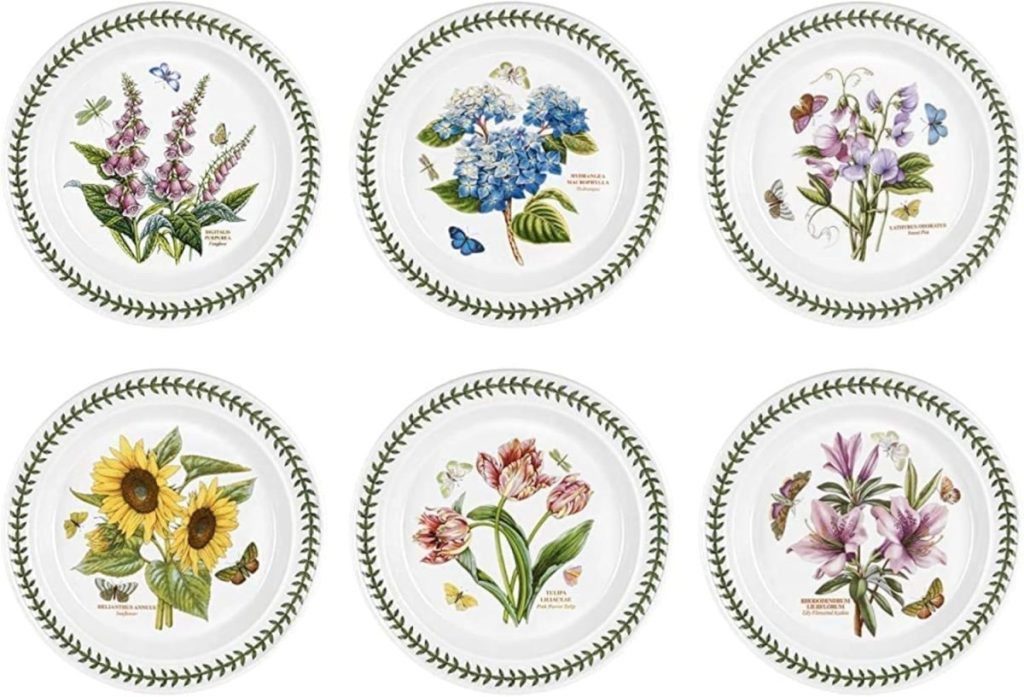 Six decorative plates, each featuring a different botanical illustration with flowers, butterflies, and greenery, arranged in two rows of three—perfect for adding a charming touch to your fall room decor.