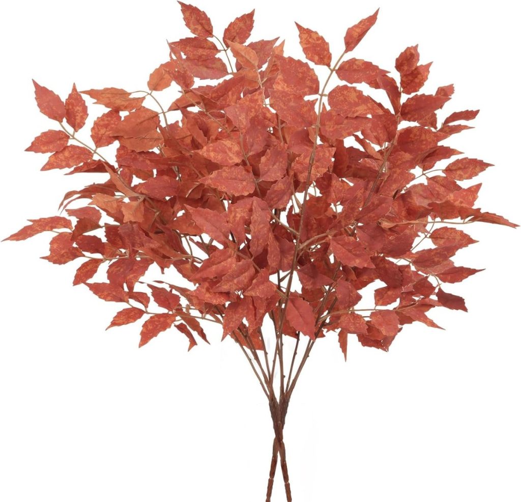 A cluster of artificial branches with reddish-orange autumn leaves against a plain white background, perfect for adding a touch of fall home decor.