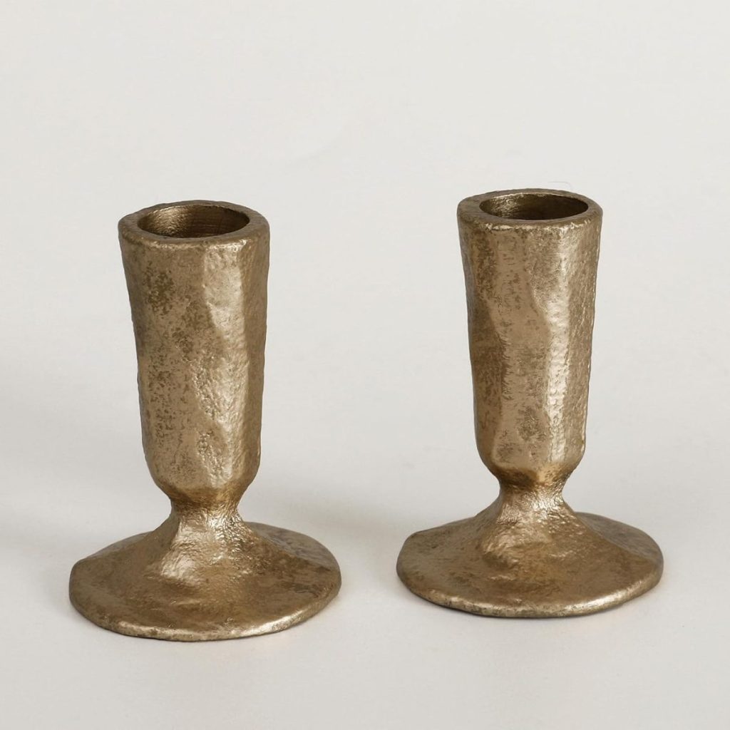 Two small, metallic, textured candlestick holders with a hammered finish are placed side by side on a plain white background, perfect for adding a touch of elegance to your fall home decor.