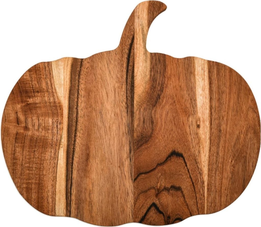 A wooden cutting board shaped like a pumpkin with visible wood grain patterns, perfect for adding a touch of fall home decor to your kitchen.