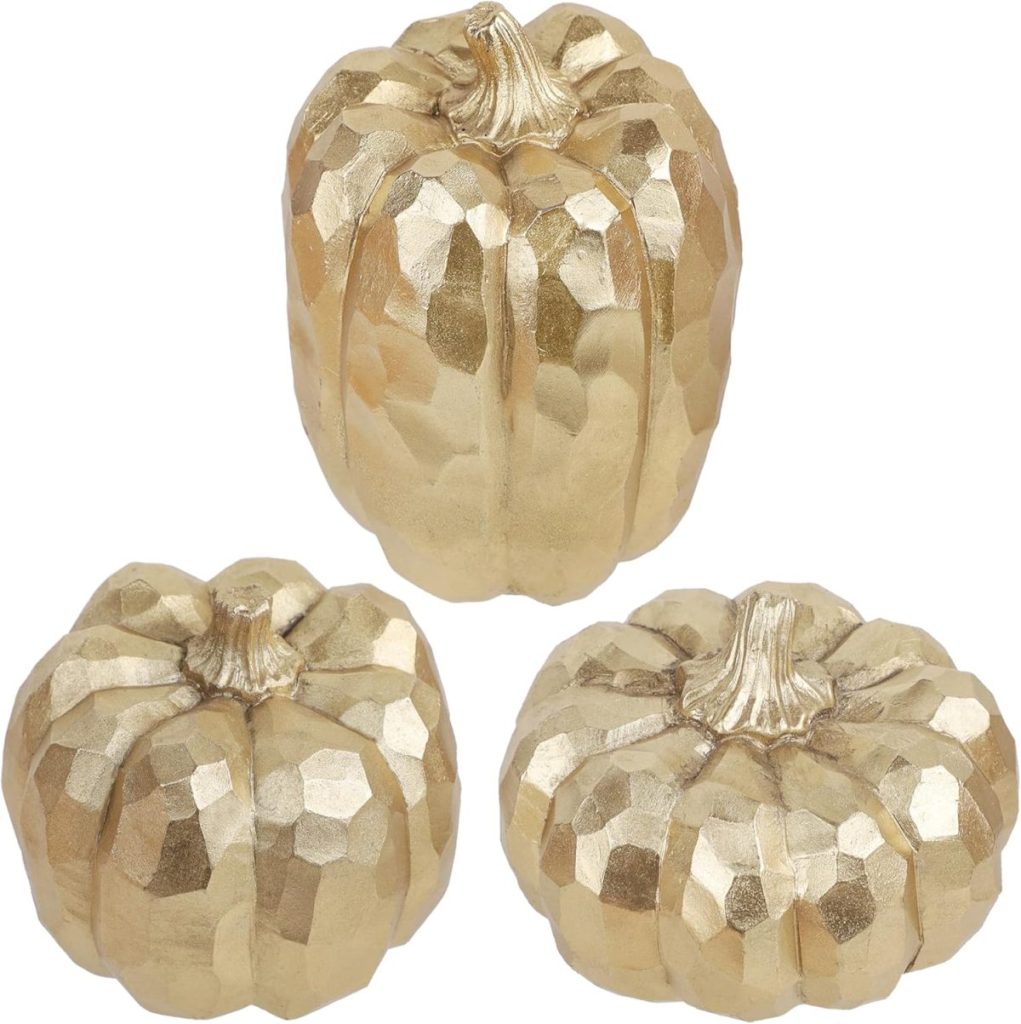 Three gold-colored, faceted decorative pumpkins are displayed against a white background, making them a chic addition to your fall home decor.