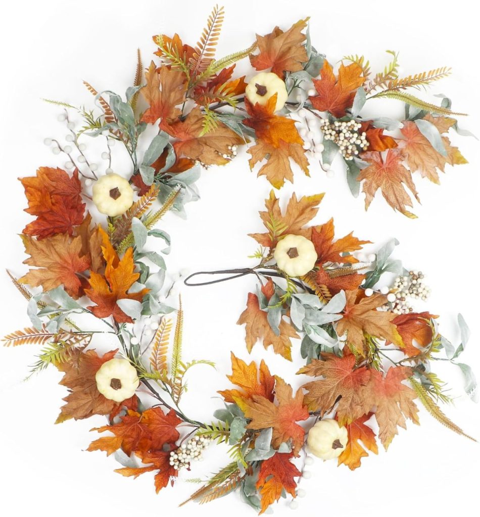 A decorative autumn wreath with orange and brown leaves, small white pumpkins, berries, and greenery arranged in a circular pattern—perfect for adding cozy fall home decor to your space.
