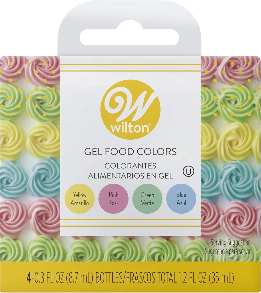 Wilton gel food colors package with four colors: yellow, pink, green, and blue. Swirled frosting designs in the background inspire vibrant flower cake creations.