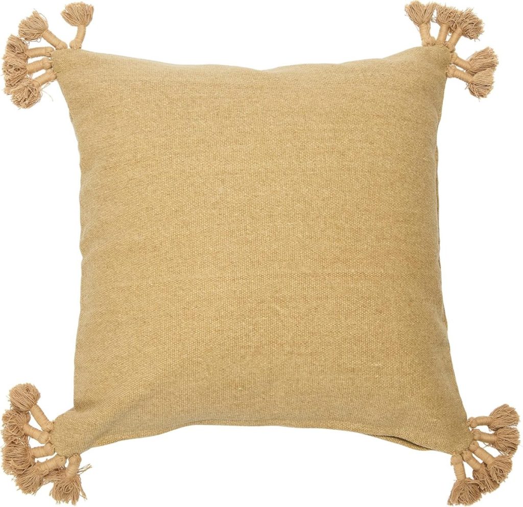 Square beige throw pillow with tassels on each corner, perfect for adding a cozy touch to your fall home decor. Shown on a white background.
