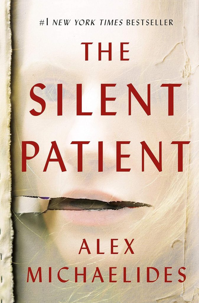 Book cover of "The Silent Patient" by Alex Michaelides, featuring a torn beige surface revealing part of a woman's face underneath—a suspenseful choice for your next house guest gift.