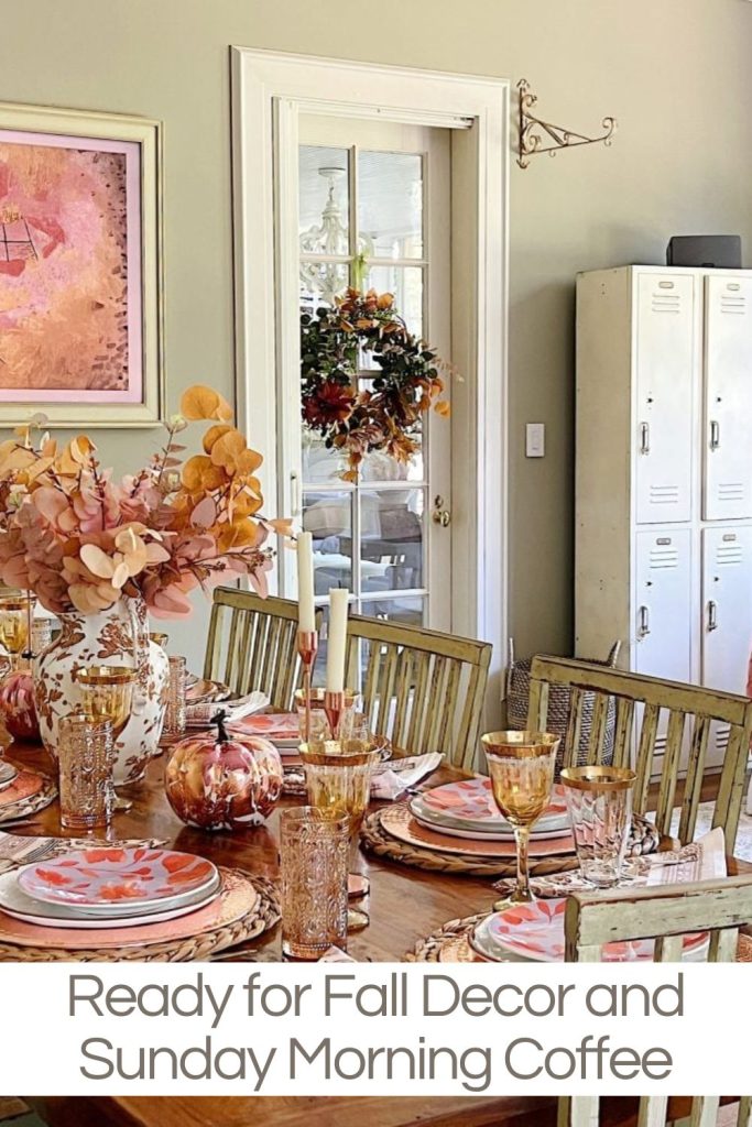 A dining table set for fall with autumn-themed decor including pumpkins, foliage, and warm-colored tableware. A wreath adorns the door in the background. Text reads: "Ready for Fall Decor and Sunday Morning Coffee.