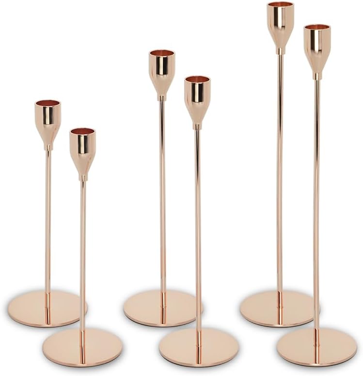 Six gold-colored metal candle holders of varying heights are arranged in two rows against a white background, perfect for adding a touch of elegance to any farmhouse table setting.