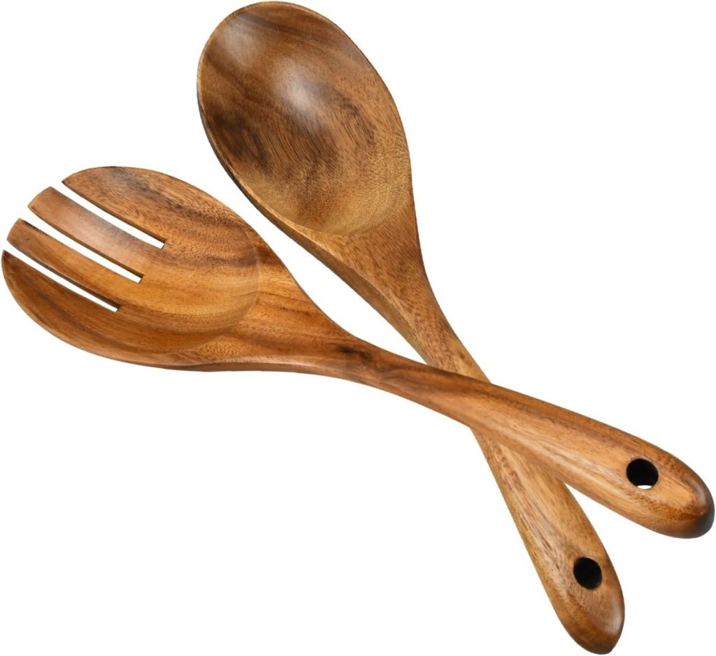 A wooden Harvest Salad serving set consisting of a spoon and a fork with round handles, crossed over each other on a white background.