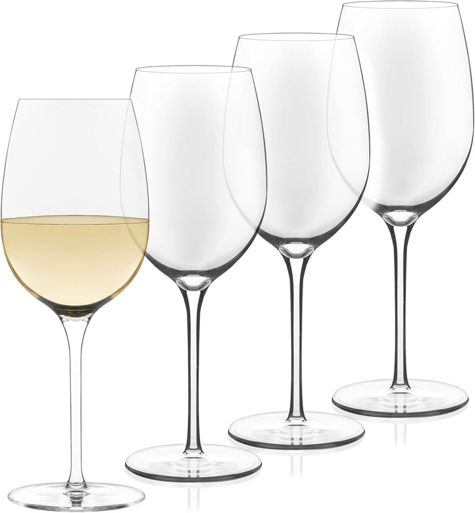 Four clear wine glasses are shown; one has a small amount of white wine, while the other three are empty.