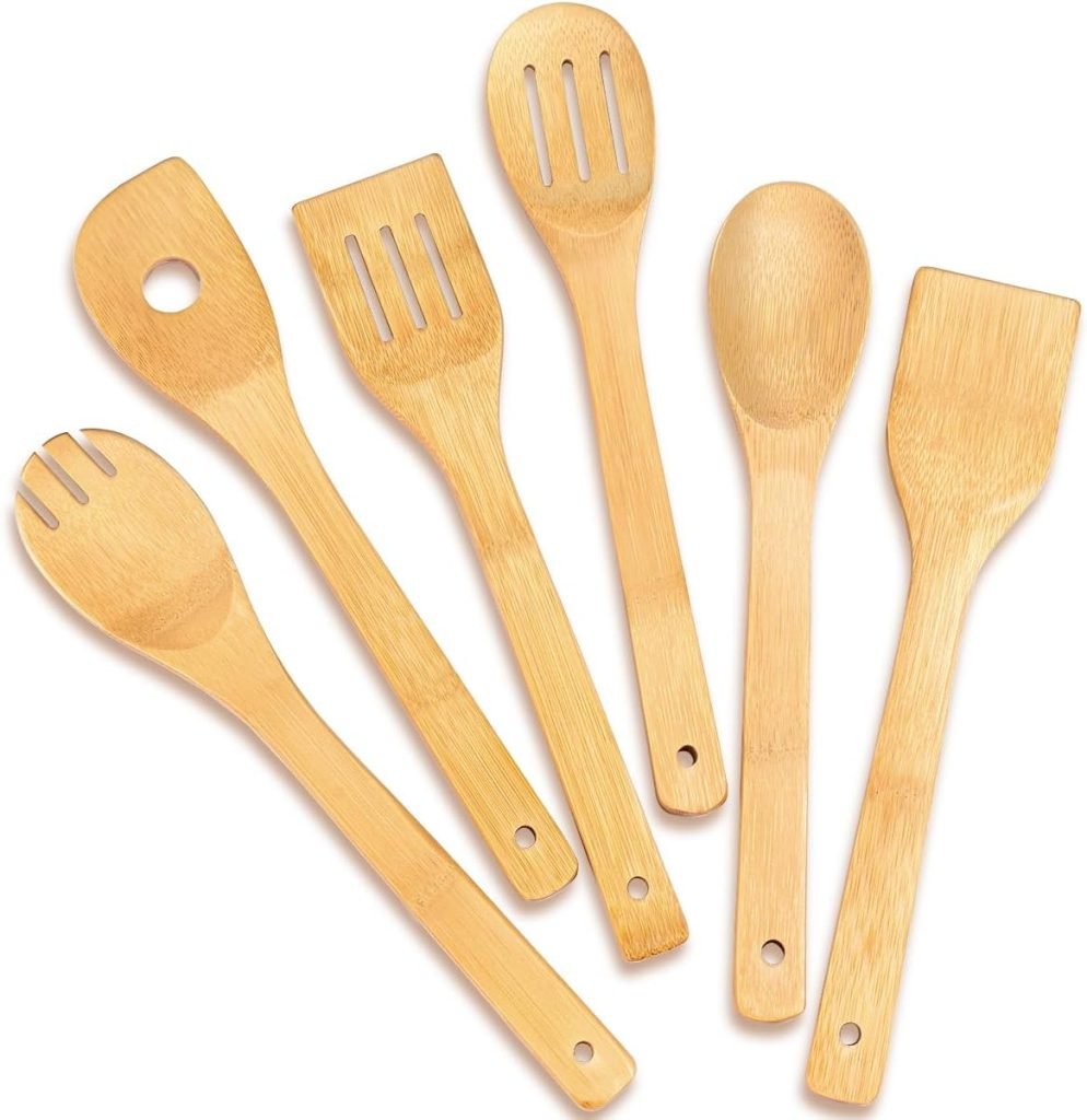 A set of six wooden kitchen utensils, including spoons, spatulas, and a slotted spoon, arranged in a row.