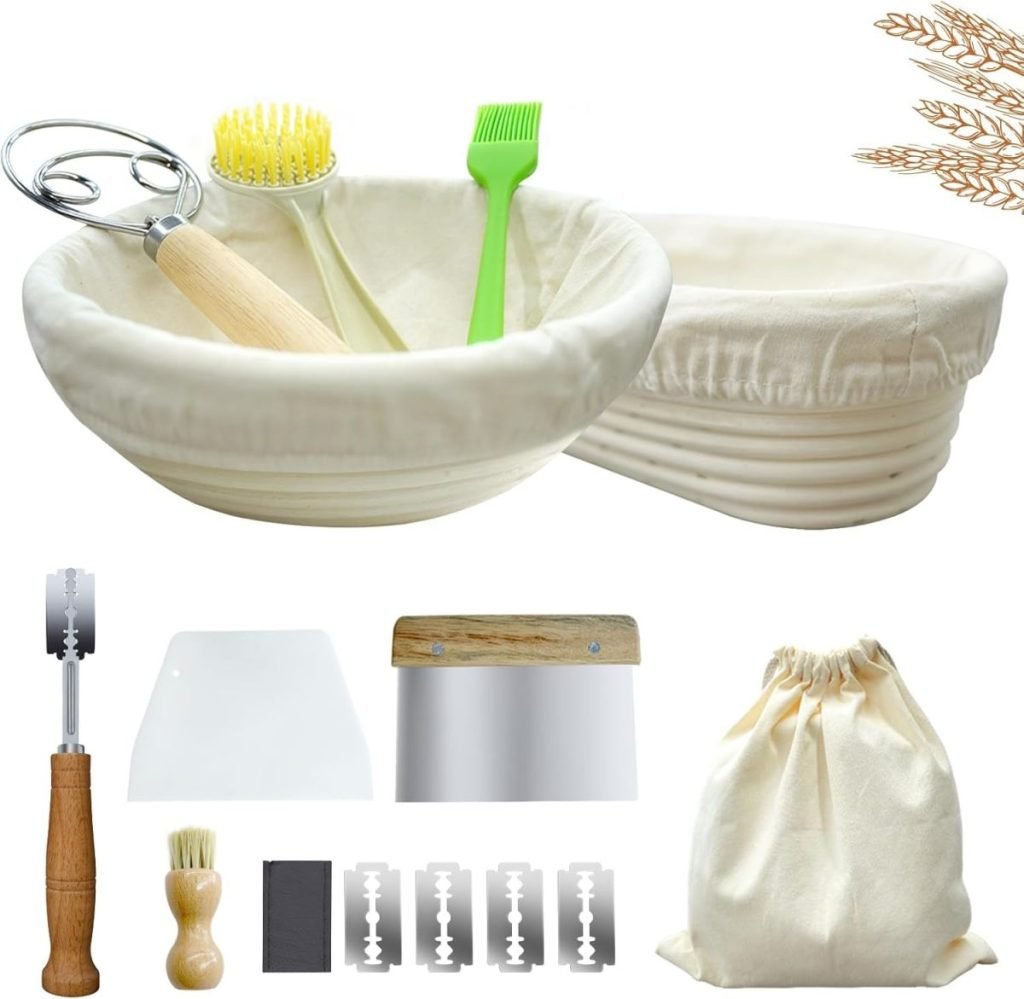 A bread-making kit includes banneton baskets, a dough whisk, a silicone brush, a bench scraper, a dough scraper, a small brush, a scoring tool, razor blades, and a cloth storage bag, arranged neatly.