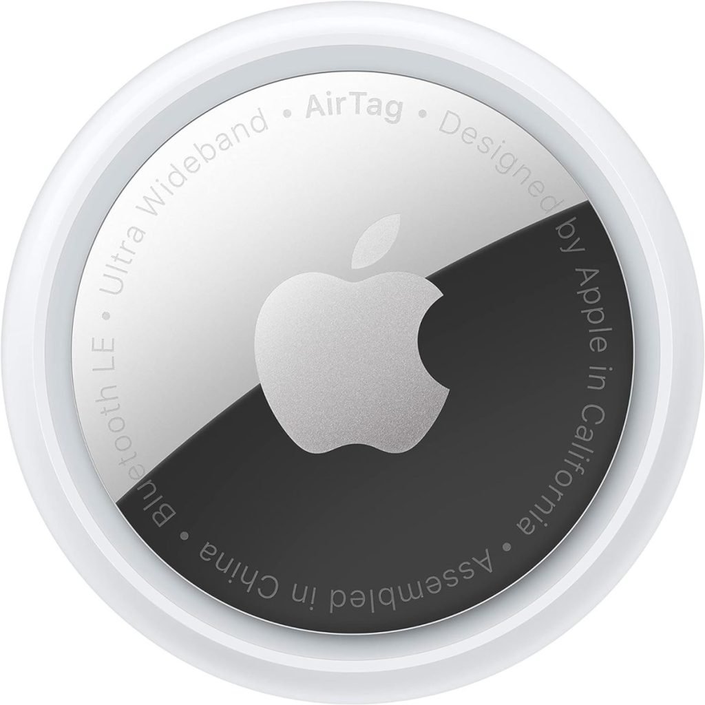 Close-up image of an Apple AirTag, displaying the Apple logo and text around the edge stating its design and assembly origins.