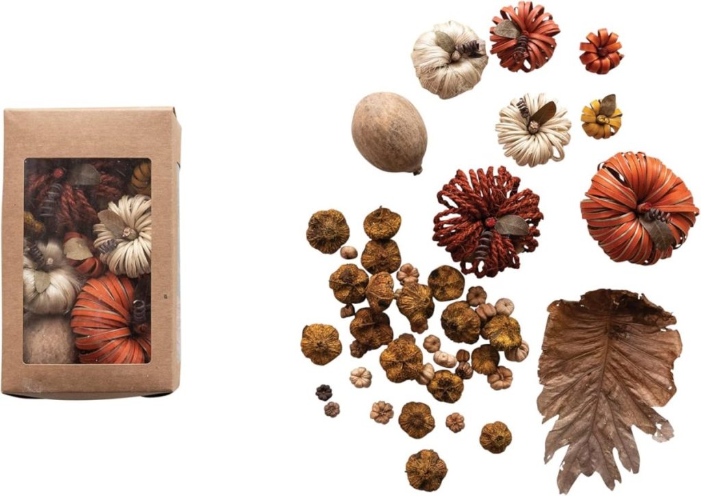 A box of assorted dried potpourri, perfect for pumpkin craft projects, sits beside a display of its contents, including decorative dried flowers, pods, seeds, and a large leaf.