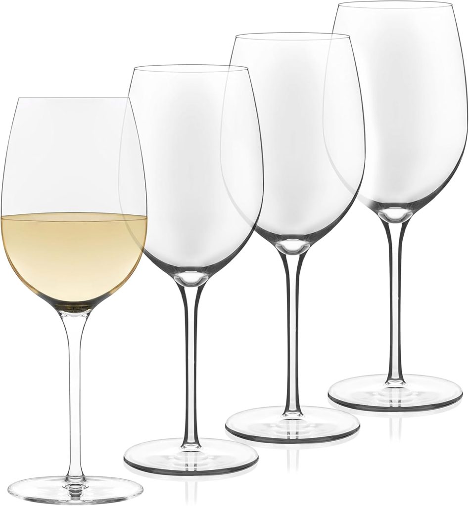 Four wine glasses, one partially filled with white wine, arranged neatly in a row alongside glass water bottles on a plain background.