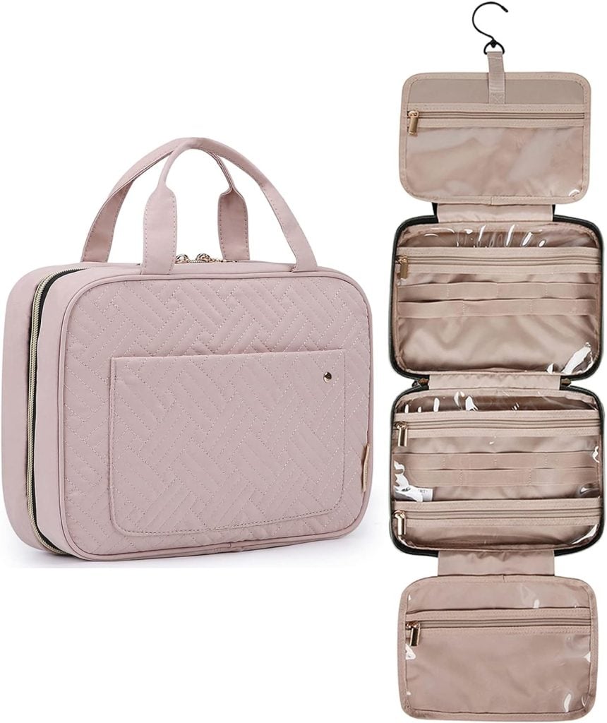 A beige travel toiletry bag with a quilted exterior and carrying handles is shown. The bag is open, revealing multiple zippered compartments and a hook for hanging.