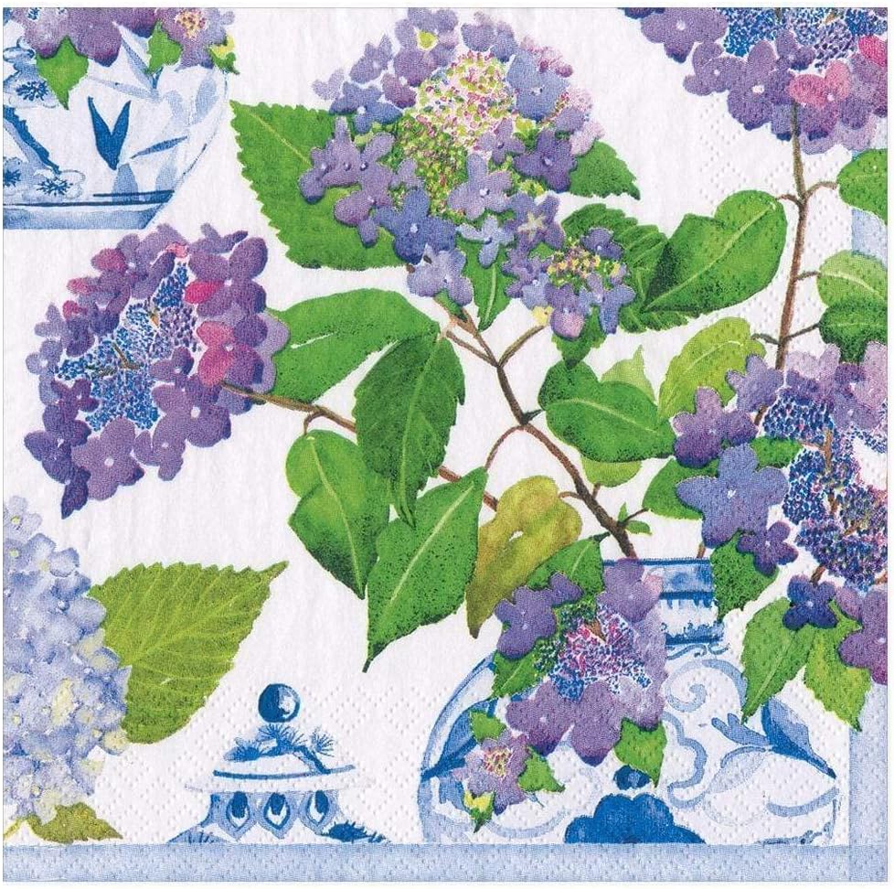 A floral-themed print featuring clusters of purple and blue hydrangeas with green leaves in blue and white ceramic vases. The background is white, adorned with additional blue floral and decorative elements, perfectly complemented by rustic wood charger plates.