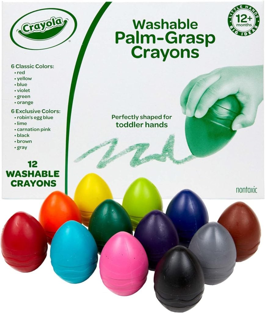 A box of Crayola Washable Palm-Grasp Crayons shows 12 egg-shaped crayons in various colors. The box highlights features, including being nontoxic and suitable for toddlers aged 12 months and older.