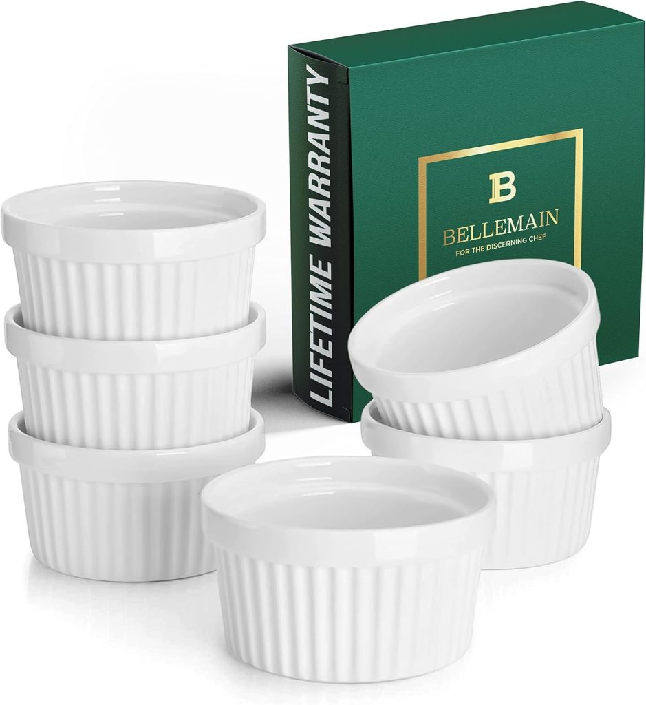 A set of six white Bellemain ramekins with a green box labeled "LIFETIME WARRANTY" in the background. The ramekins are stacked in two piles.