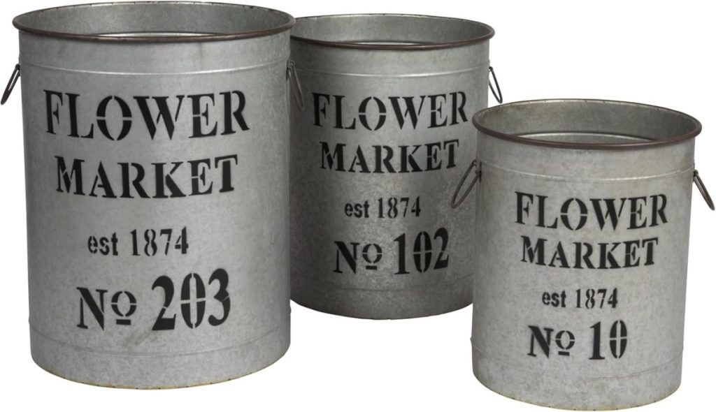 Three metal buckets labeled "FLOWER MARKET est 1874" with numbers 203, 102, and 10 are arranged side by side in descending size order—a charming touch for A Home to Share.
