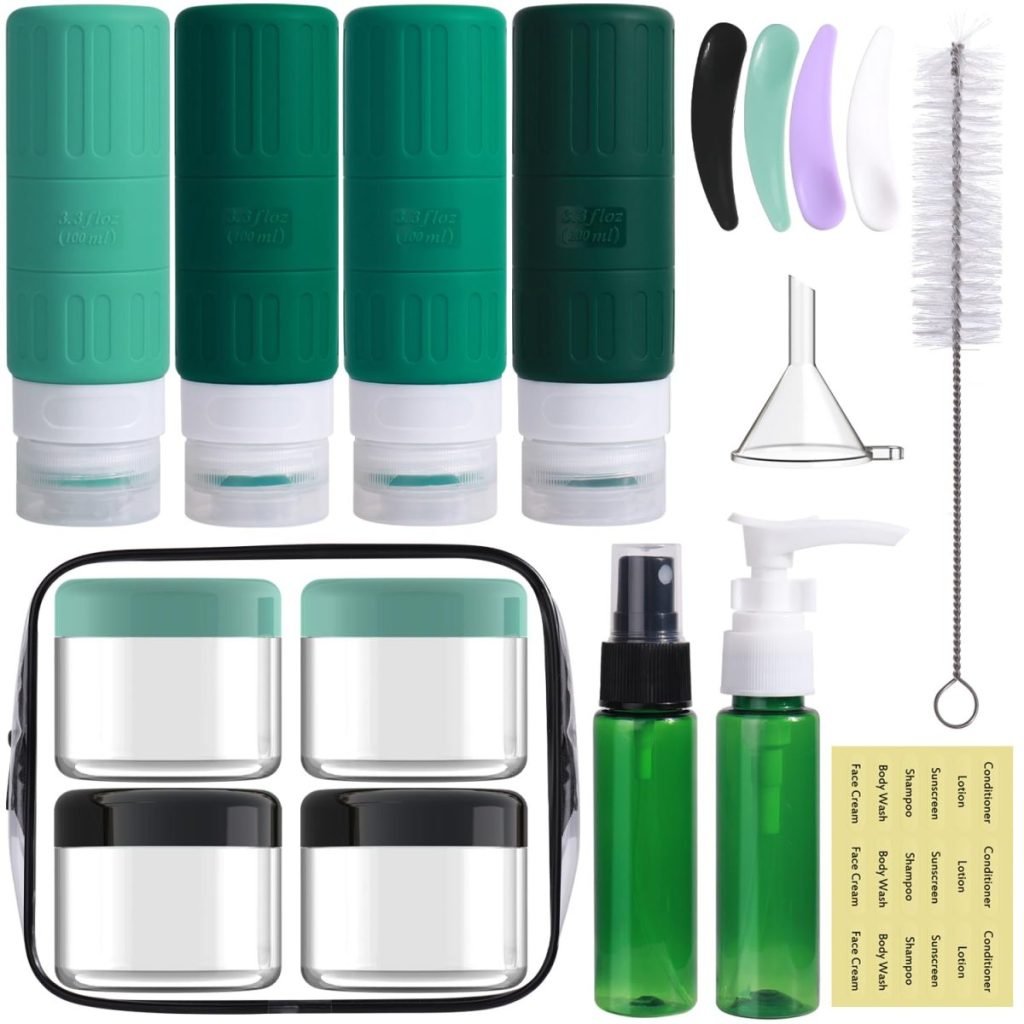 A travel toiletry set with green bottles, clear jars with black lids, a spray bottle, a pump bottle, a brush, labels, spatulas, a funnel, and a black carrying case.