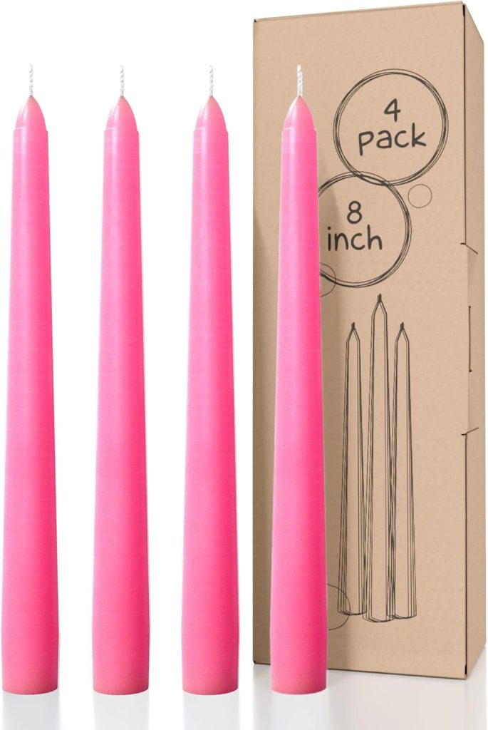 Four pink taper candles are positioned upright next to a brown box labeled "4 Pack, 8 inch" with a line drawing of the candles, perfect for complementing your fall flower arrangements.