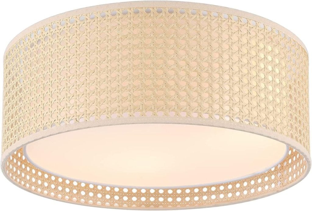 A beige, round, woven rattan ceiling light fixture with warm ambient lighting.