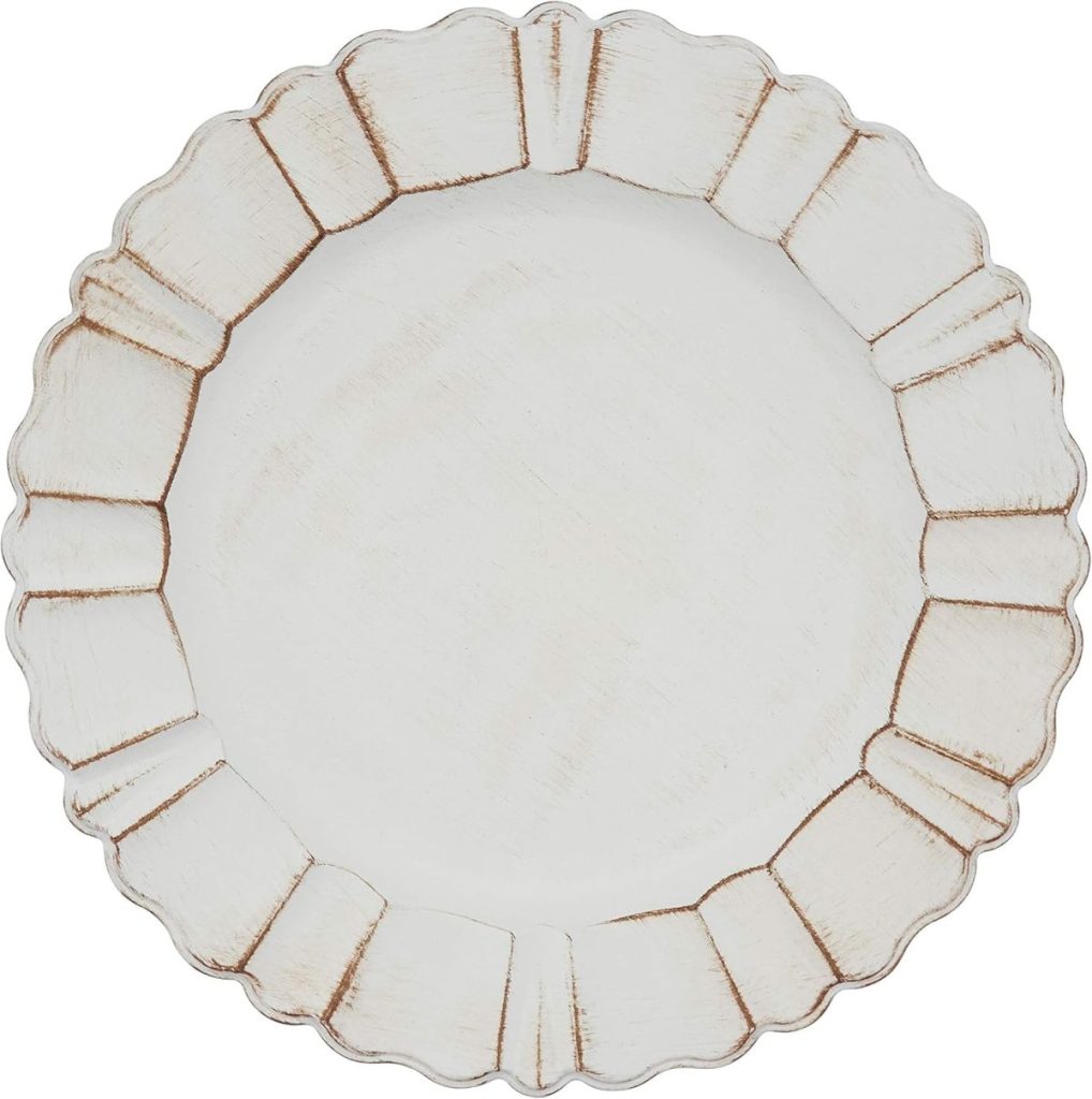 A round, off-white plate with a scalloped, textured rim and distressed, rustic finish—perfect for pairing with wood charger plates for a charming tablescape.