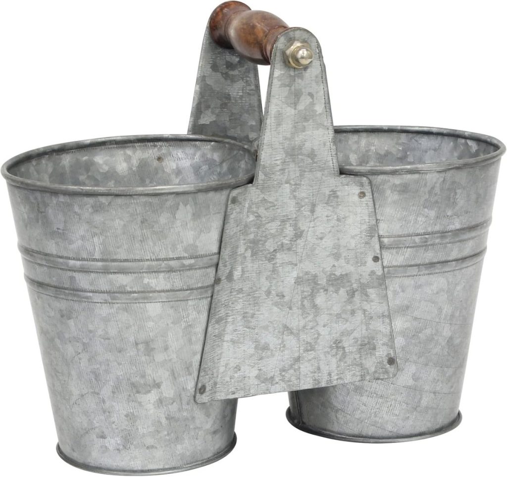 A dual galvanized metal bucket with a wooden handle, perfect for carrying water or creating charming fall flower arrangements.