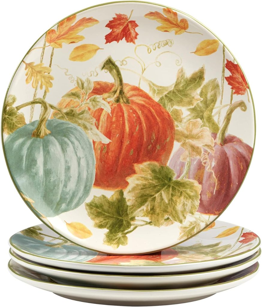 A set of four ceramic plates stacked on top of each other, each featuring a colorful autumn-themed design with pumpkins and leaves, ideal for placing on wood charger plates to elevate your seasonal dining experience.