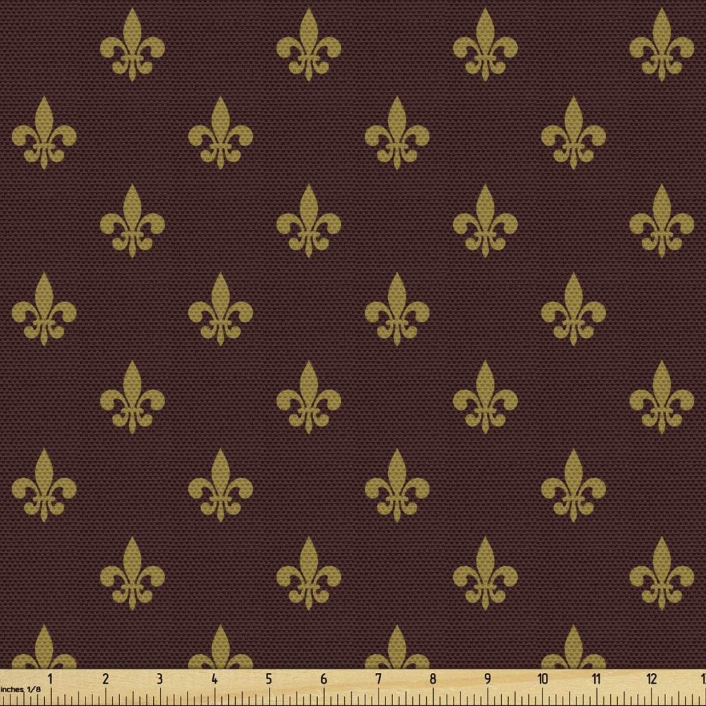 Repeating gold fleur-de-lis pattern on a dark brown background, with a yellow measuring ruler along the bottom edge showing inches—perfect for pairing with fall pumpkins in seasonal projects.