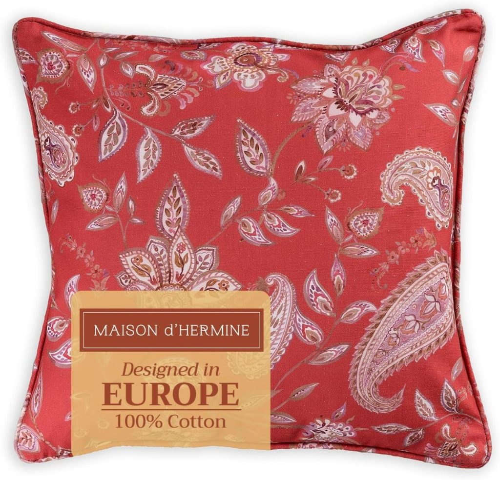 Square red pillow with a paisley and floral pattern, perfect for fall décor. Label reads "Maison d’Hermine, Designed in Europe, 100% Cotton." A stylish choice for updating your space with cozy fall pillow covers.