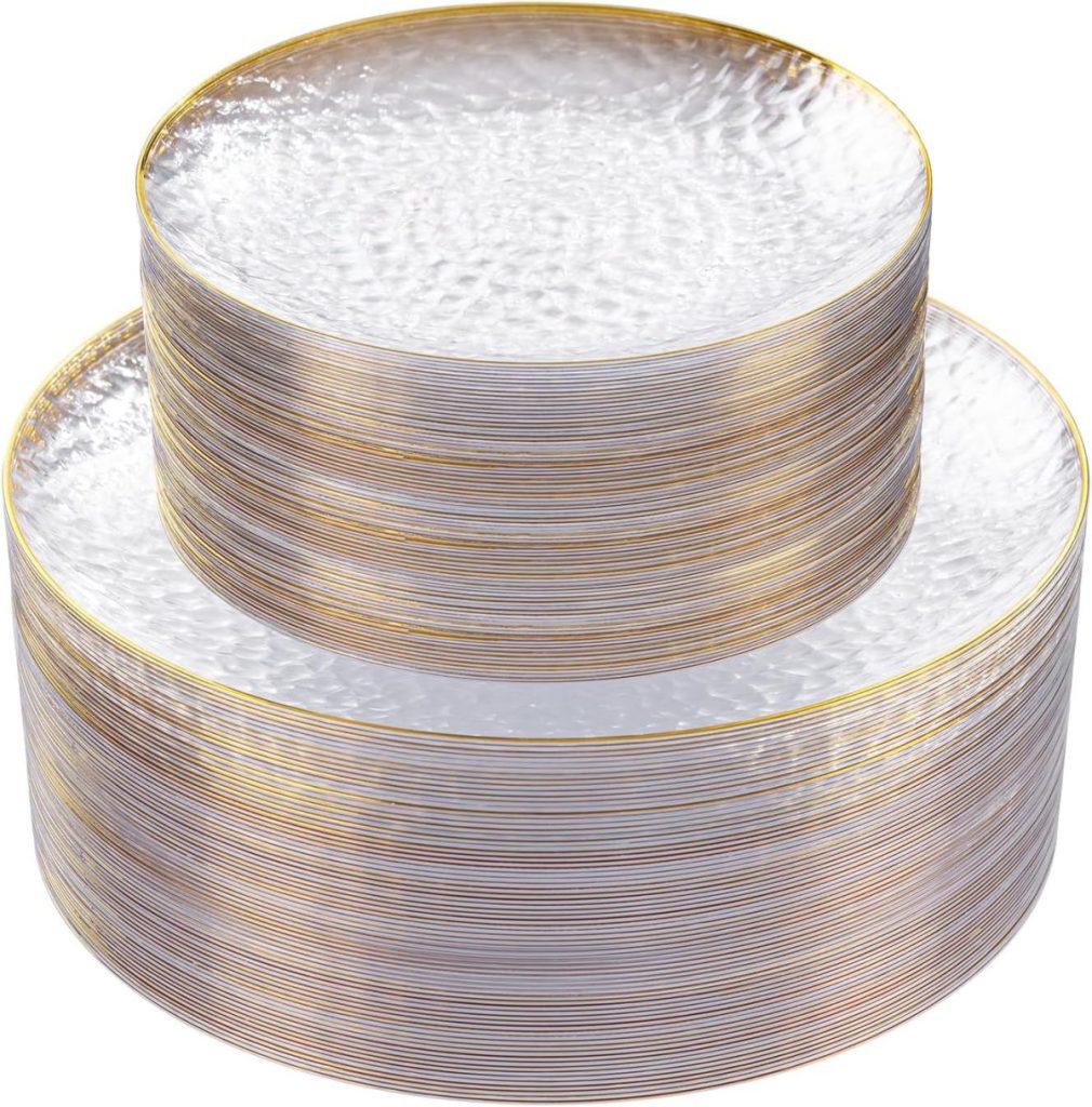 Two stacks of round, clear plastic plates with a gold rim, one larger than the other, are displayed against a white background—perfect for gatherings inspired by A Home to Share.