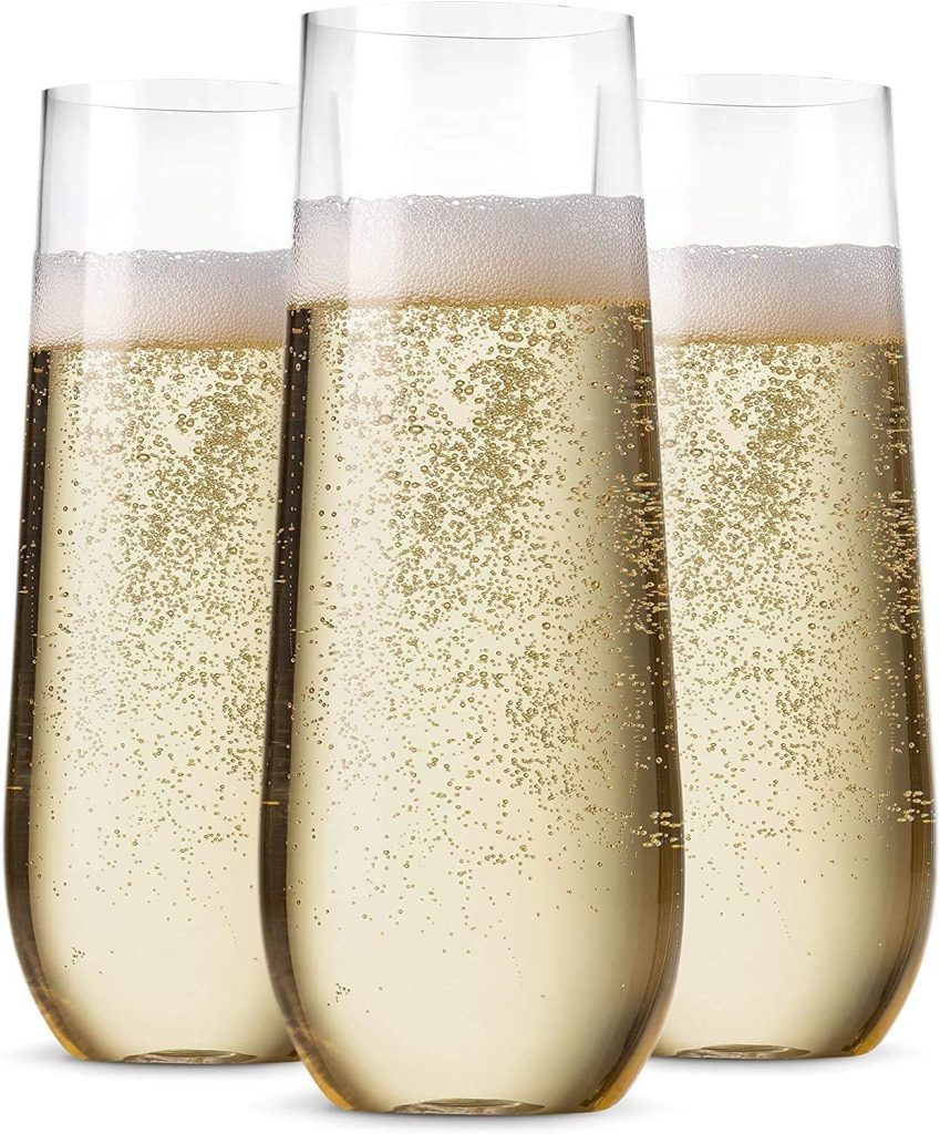 Three clear, stemless champagne flutes filled with sparkling wine, bubbles rising and foam at the top—perfect for celebrating special moments in A Home to Share.