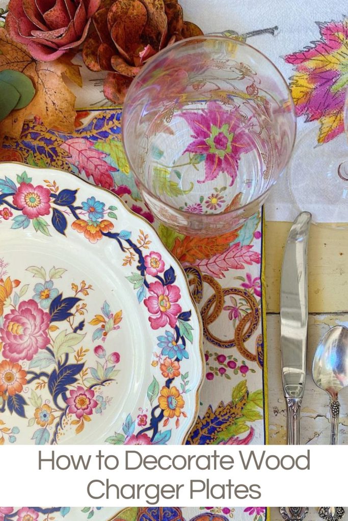 A vibrant table setting featuring a floral-patterned plate, a glass, silverware, and colorful fabric napkins. Text overlay: "How to Decorate Wood Charger Plates.