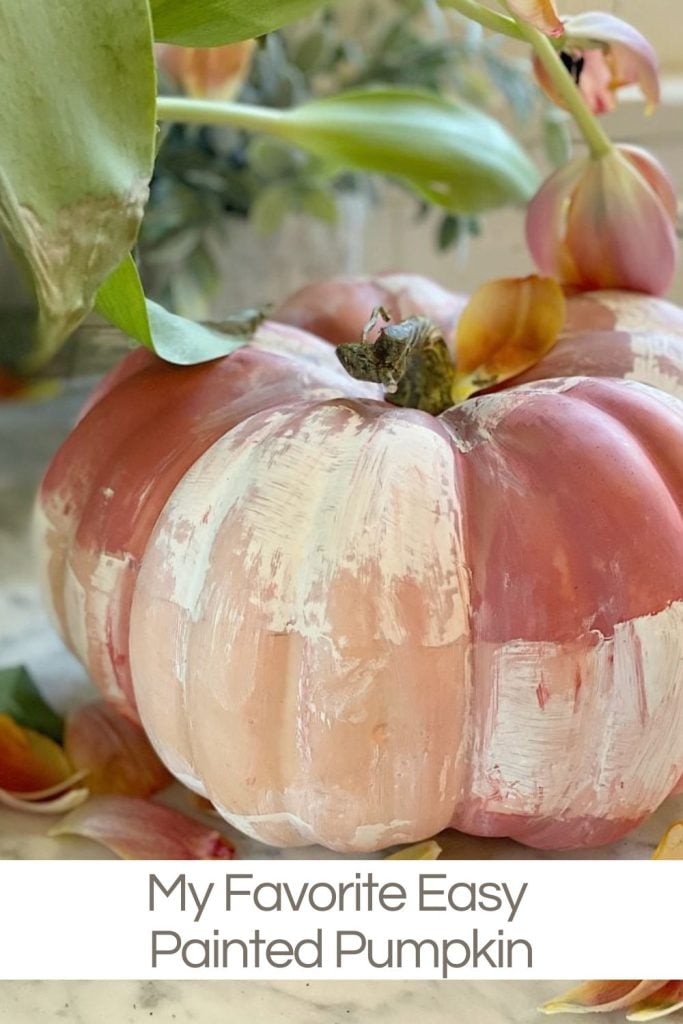 A pumpkin painted with shades of pink and white is displayed with some leaves and petals around it. The text at the bottom reads, "My Favorite Easy Painted Pumpkin.