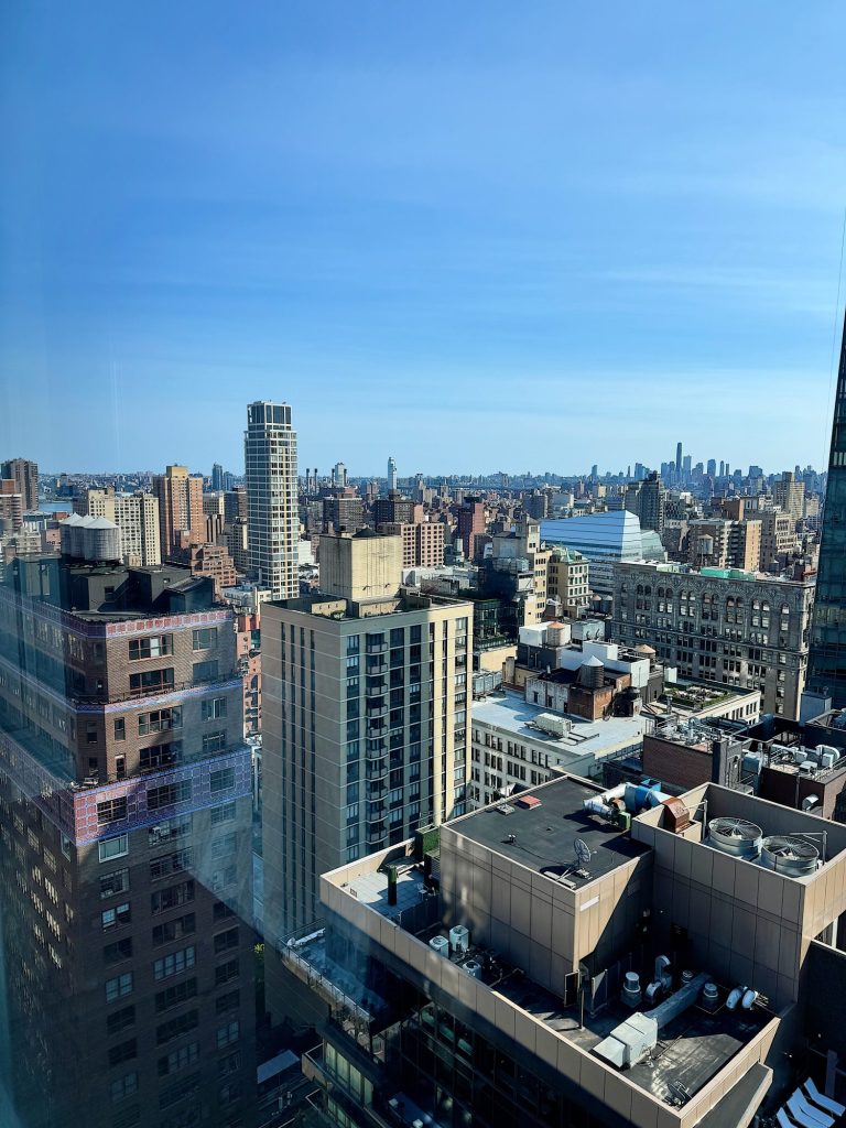 View of a cityscape with various high-rise buildings under a clear blue sky during daytime.