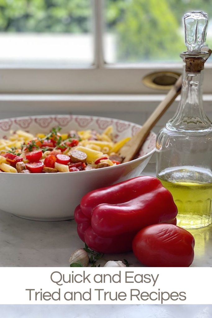 Bowl of pasta with wooden spoon, bell peppers, and bottle of olive oil on counter near window. Text overlay reads "Quick and Easy Tried and True Recipes.