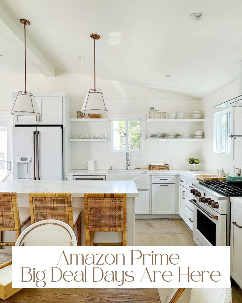 Bright, modern kitchen with white cabinets, a large island with wicker chairs, and a message overlay: "Amazon Prime Big Deal Days Are Here." Enjoy exclusive savings while transforming your space.