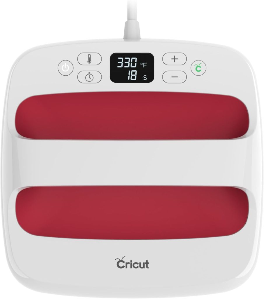 A Cricut heat press machine available on Amazon Prime features a digital display showing 330°F and 18 seconds, complete with vibrant red heating plates.