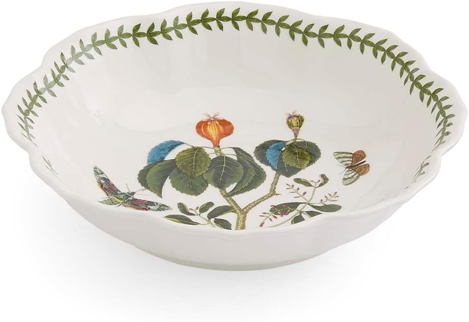 White ceramic bowl with scalloped edges, decorated with a green leaf border and a botanical illustration of flowers, leaves, and butterflies inside—perfect for serving fresh fettuccini in style.
