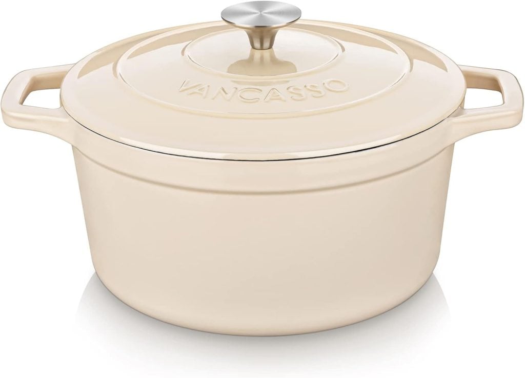 Cream-colored Dutch oven with a lid and side handles, marked "Vancasso.