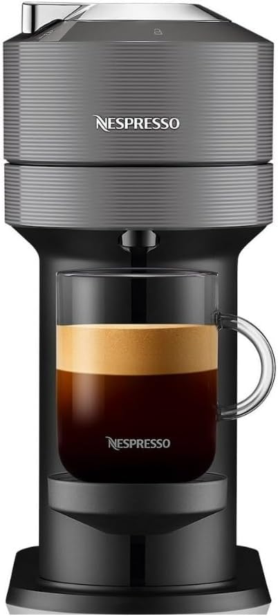 A Nespresso coffee machine sits proudly, brewing a rich cup of coffee with velvety crema into a logo-emblazoned glass. Perfect for those cozy moments, this machine is conveniently available through Amazon Prime.