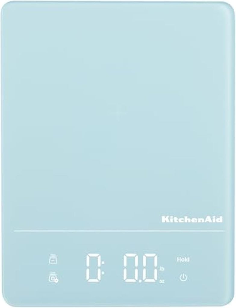A light blue KitchenAid digital kitchen scale with a flat surface and an illuminated display showing zero—perfect for precise measurements when learning how to make a sourdough starter.