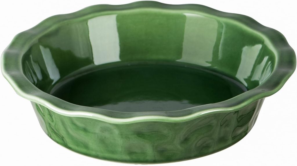 A green ceramic pie dish with a wavy edge, perfect for crafting a delicious sourdough pie crust.